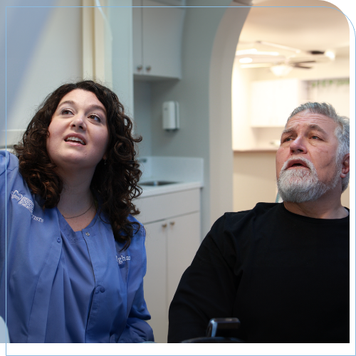 Dental team member showing a patient something out of frame