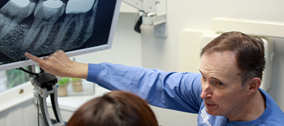 Doctor Scott showing a patient an x ray of their teeth