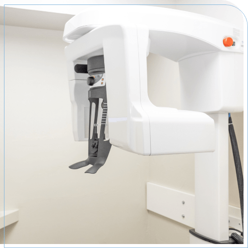 C T cone beam scanner standing against white wall