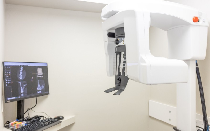 C T cone beam scanner standing against white wall