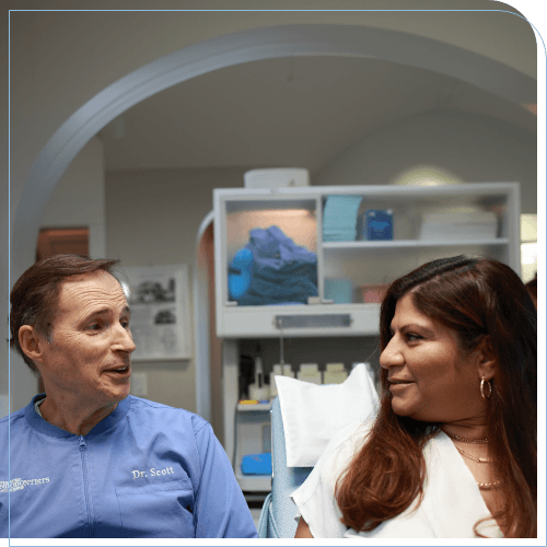 Doctor Scott talking to a woman in the dental chair