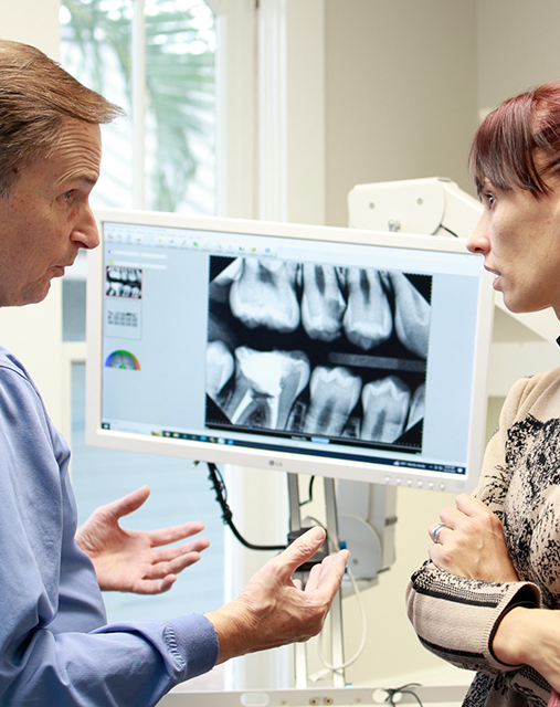 Doctor Scott talking to a patient about root canal treatment in Melbourne
