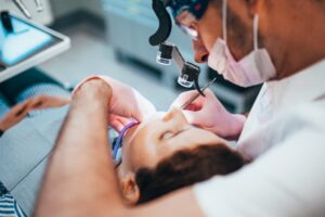 Dentist operating on patient.
