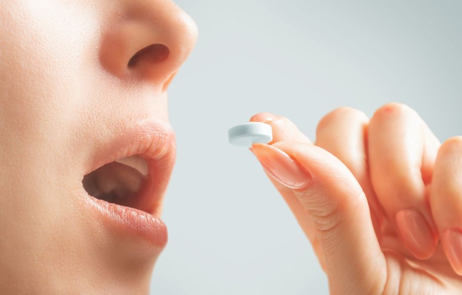 A woman taking an oral sedative